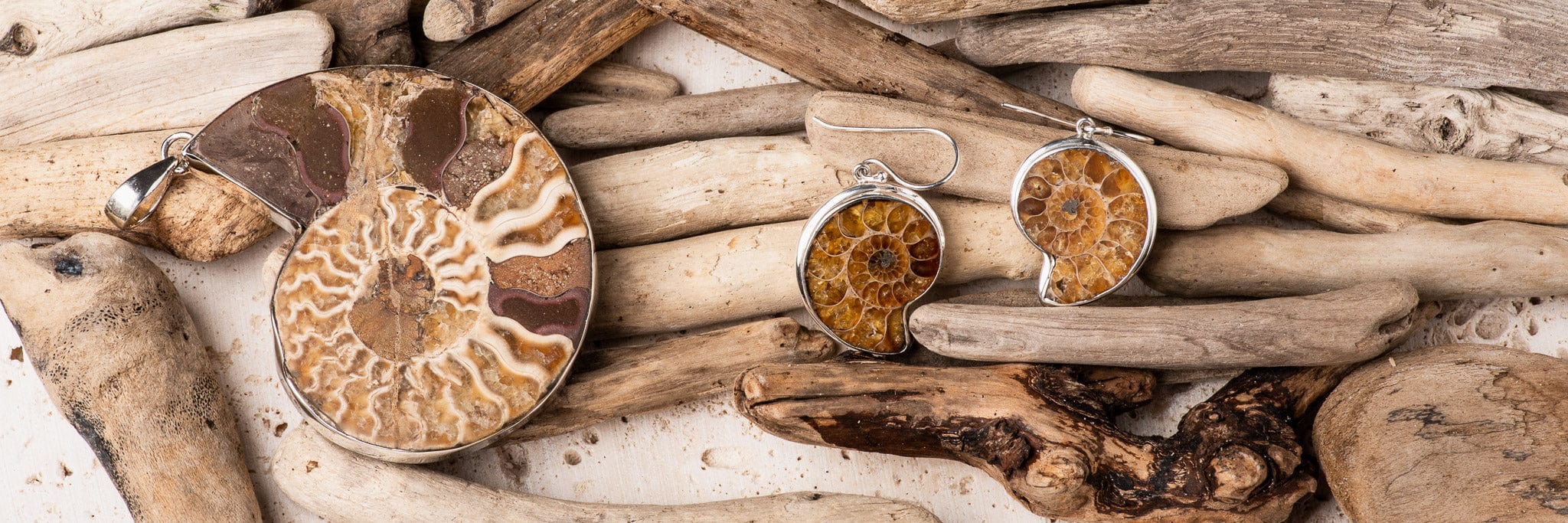 Sterling Silver Fossil Jewellery. Ammonite jewellery, ammonite earrings, ammonite pendant on a driftwood background.