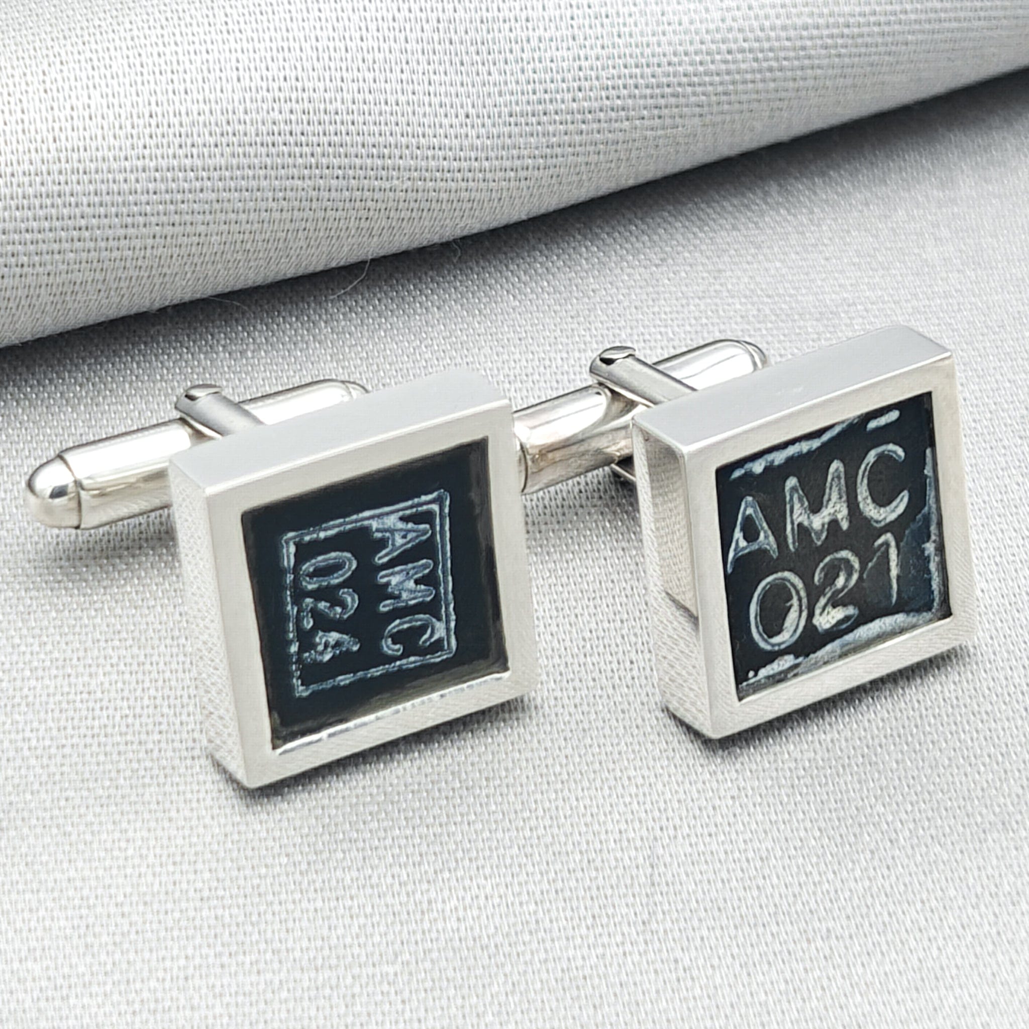 chinook cufflinks on pale background with AMC text visible from instrument panel