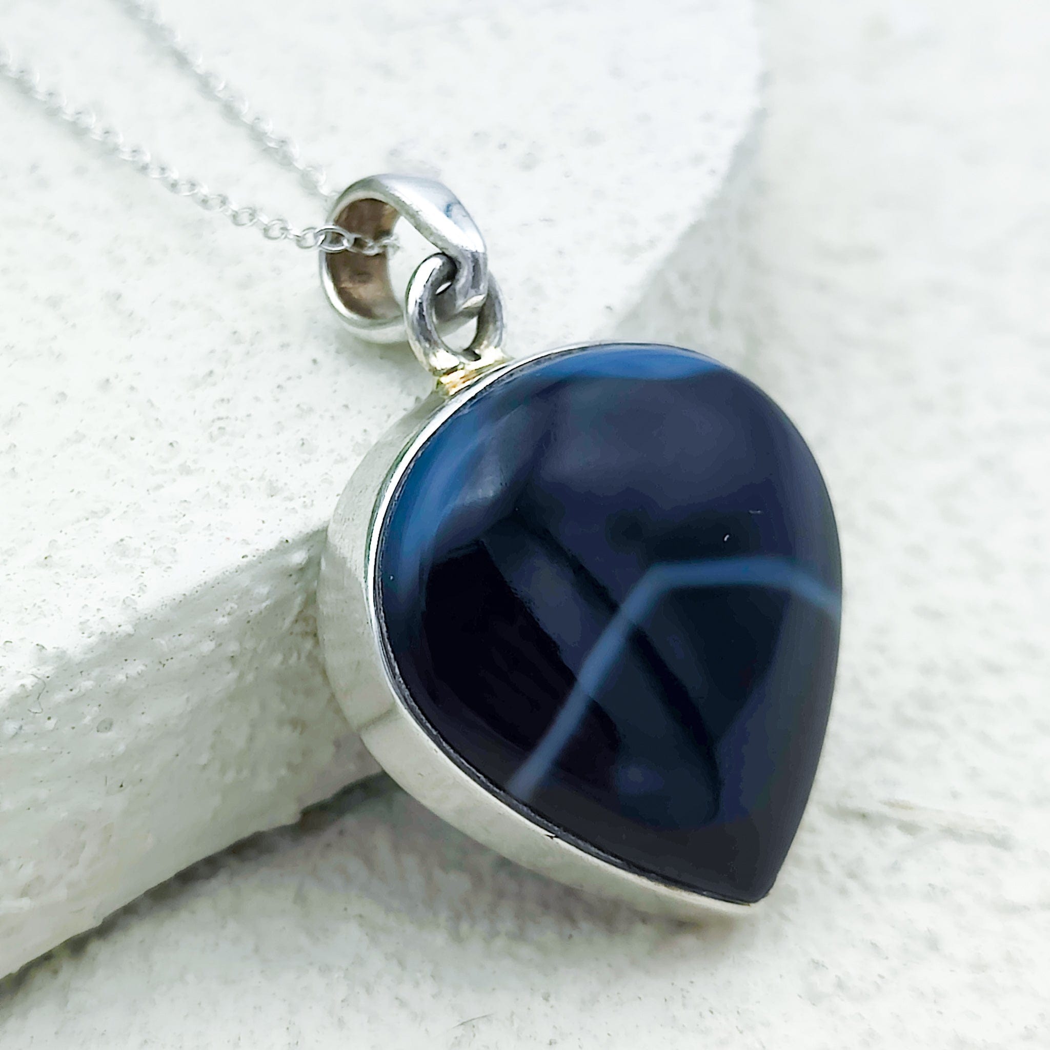 Black onyx pendant with white bands in sterling silver