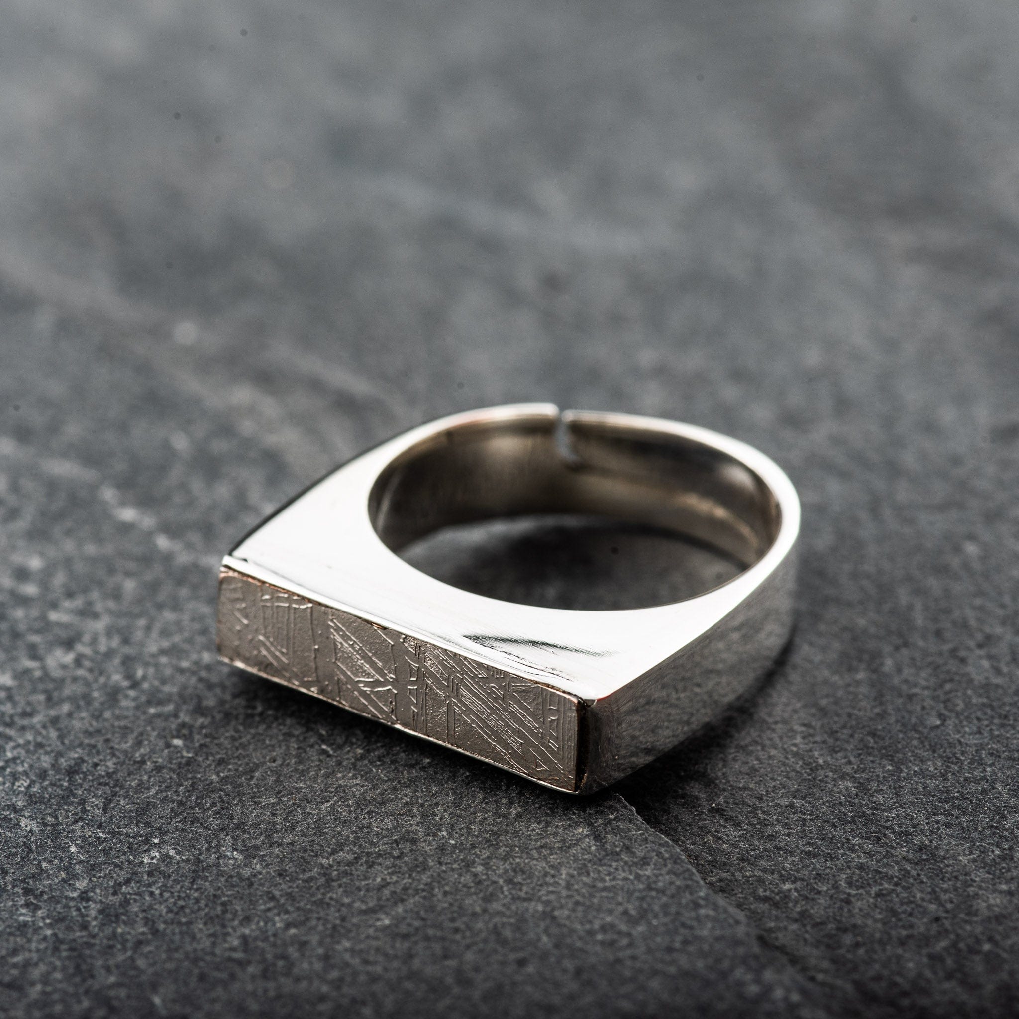 silver rectangular ring with a meteorite centre