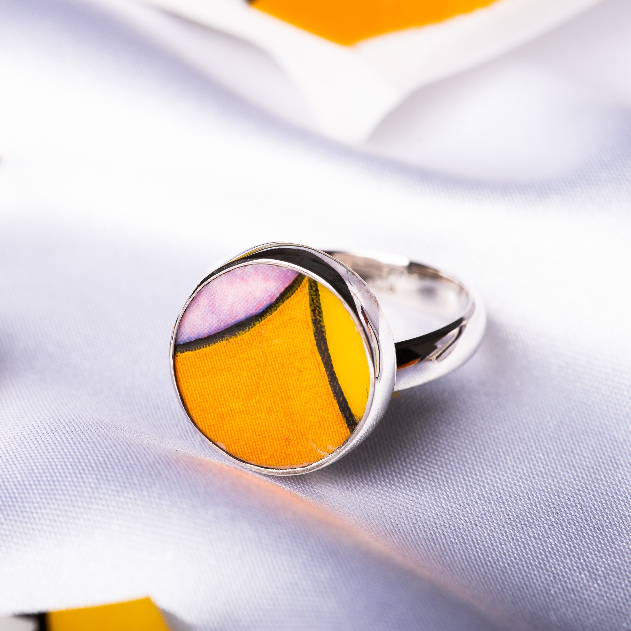 A Clarice Cliff ring, in orange, pink and yellow, captured in Sterling Silver using Clarice Cliff pottery. 