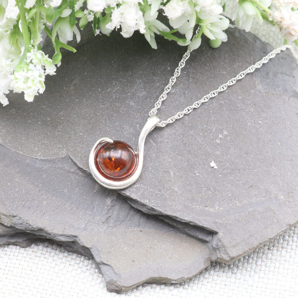Hepburn and Hughes Baltic Amber Pendant, Circular stone with swirl in Sterling Silver